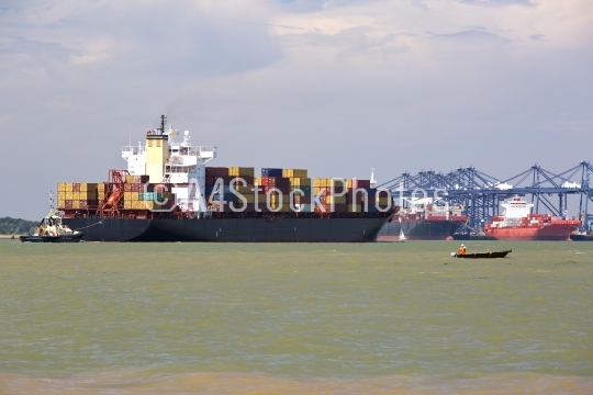 Container ship being guided into port