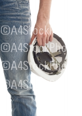 Male engineer in jeans holding white hardhat
