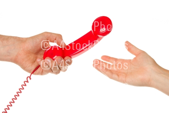 Man giving red telephone to woman