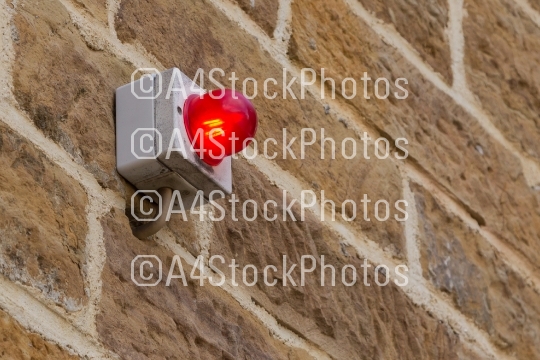 Red light on a brick wall