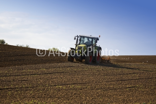 Tractor ploughing an undulating field