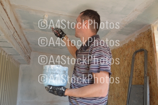 A man works in the interior of the repair and construction