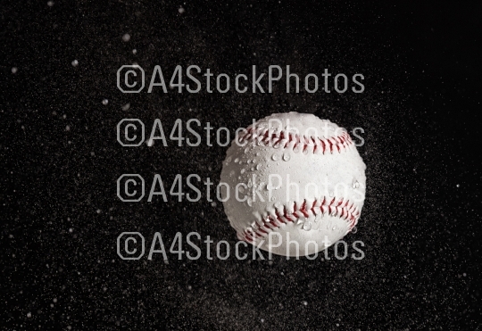 Baseball ball flying in the rain.