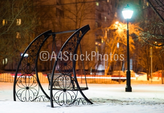 Bench in Moscow evening park background