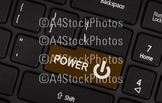 Brown power button on a black laptop keyboard