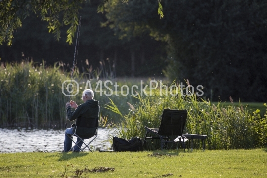 Coarse angler adjusting his float fishing gear