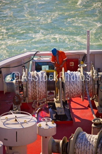Deckhand securing ropes