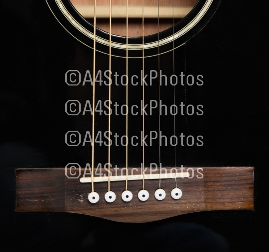 Detail of an acoustic black guitar