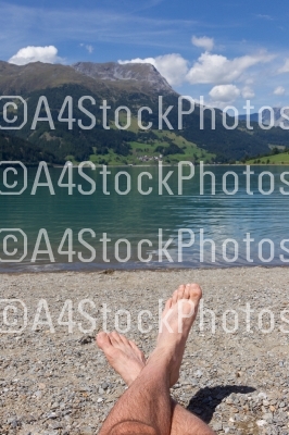 Feet on the beach, relaxing at the Reschensee