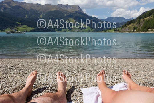 Feet on the beach, relaxing at the Reschensee