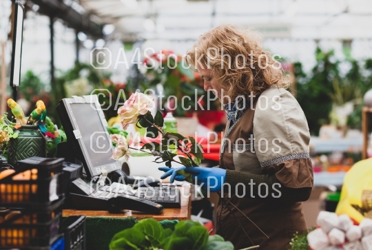 Florist with professional clothing in a nursery.