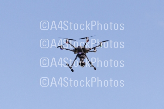 Flying drone with blue sky background