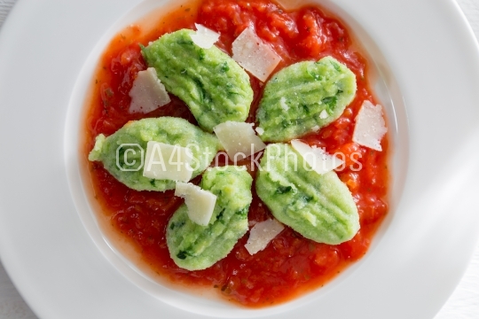 Gnocchi with wild garlic in tomato sauce and parmesan cheese
