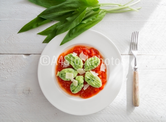 Gnocchi with wild garlic in tomato sauce and parmesan cheese