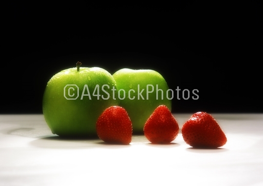Green apples and red strawberries