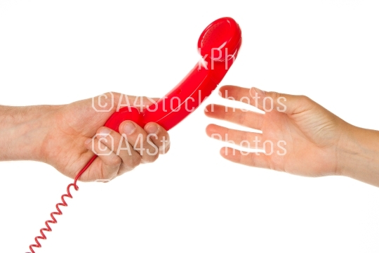 Man giving red telephone to woman
