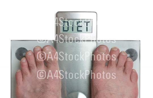 Man's feet on weight scale - Diet