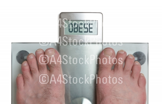 Man's feet on weight scale - Obese