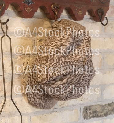 Old farmers hat hanging on a hanger