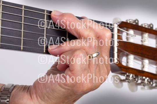 Old hand and guitar isolated