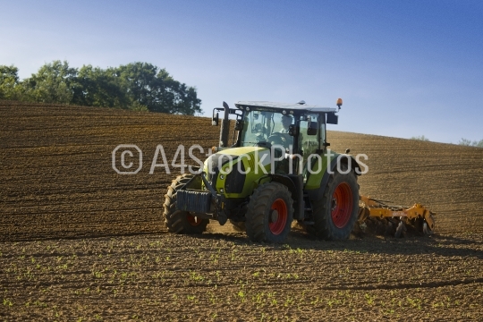Ploughing a summer field