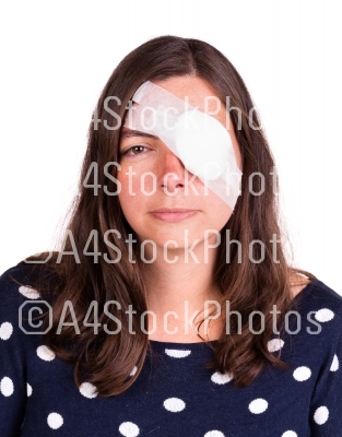 Portrait of woman wearing eye patch as protection after injury