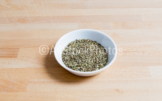 Provencal herbs in a bowl on wood