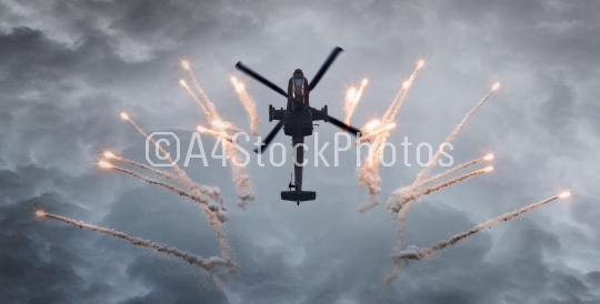 Silhouette of an attack helicopter firing flares