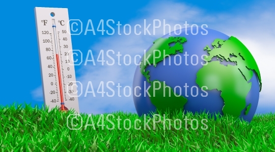 Thermometer and globe on the grass
