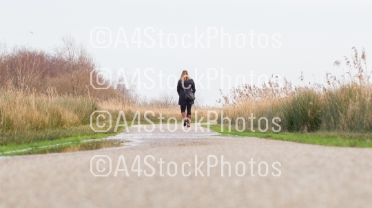 Young woman walking in a dutch landscape