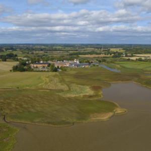 snape maltings, suffolk, coast, coastal marshes, benjamin britten, concert hall, tourist spot, river Alde, suffolk heritage coast, east anglia, horizon, blue sky, skyline, drone photo,